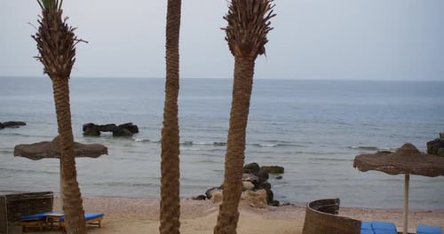 View of Chairs and Table at Seashore on Beach Resort Against Sky