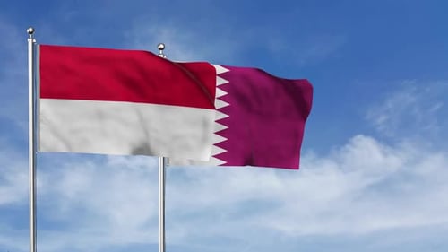Waving Indonesia and Qatar National Flags against Blue Sky