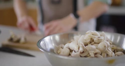 Chef Preparing a Dish with Mushrooms