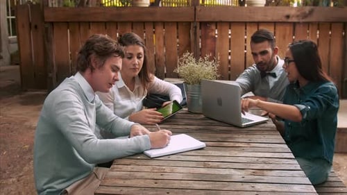 University students study together using technology preparing for exams