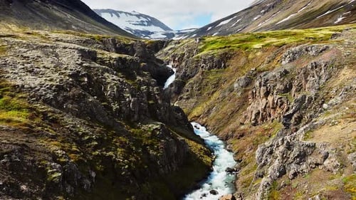 River Flows in a Mountain Crevice Flight Along the Canyon Nature in Iceland