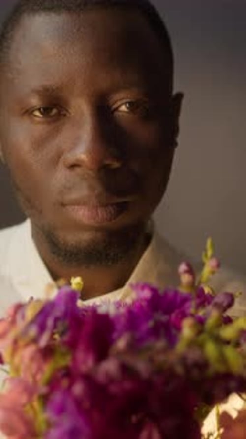 Close Up Portrait of Black Man Holding Flower Bouquet