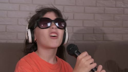 Young Girl with Microphone Singing at Home