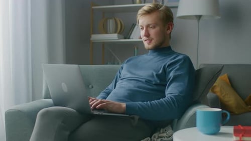 Man Relaxing at Home Using Laptop