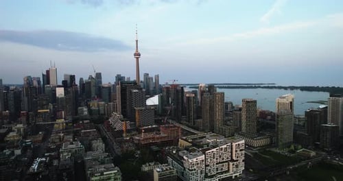 Aerial view away from downtown Toronto, sunset in Canada - pull back, drone shot