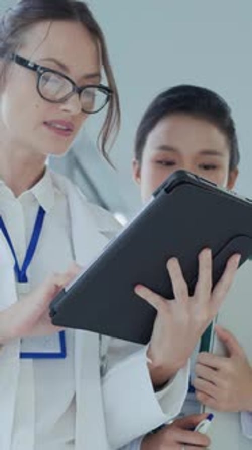 Two Medical Professionals Looking at a Tablet