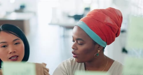 Women Collaborating on Ideas in Modern Office