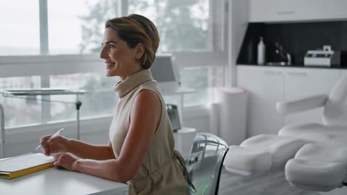 Happy Woman Visiting Cosmetology Clinic Talking with Expert