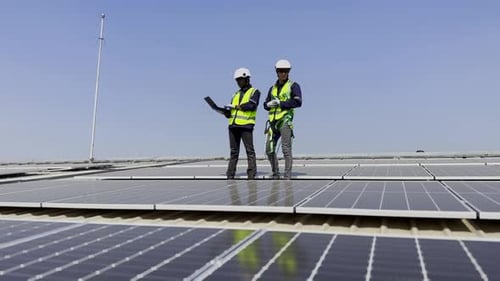 Technician installing solar cell. Installation and maintenance of solar cells on rooftop.