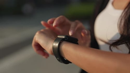 Woman Hand Texts on Smartwatch Wearing on Elegant Wrist on City Street Closeup