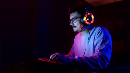 Young Adult Using Laptop in Dark Room