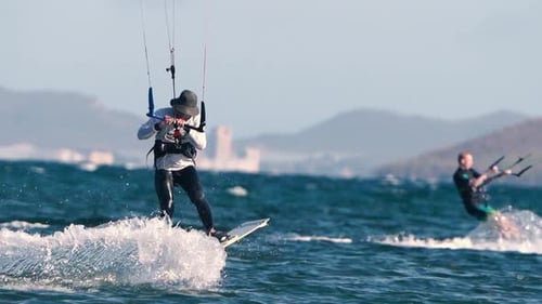 Sportsman practicing kite surf sport at the beach on a windy day at the Spanish coasts