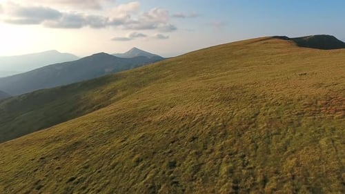 Aerial View of Mountain Ridge Flight Over Summit in Sunny Summer Day
