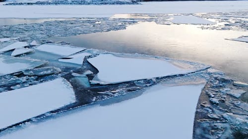 Drone's perspective as it reveals the grandeur of ice masses on the water.