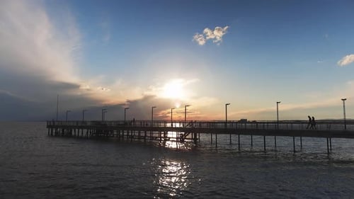 Side View of the Pier on the Black Sea Against the Background of the Sky and Sunset