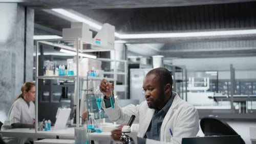 Spécialiste du développement d'essais en laboratoire étudiant un polymère liquide bleu