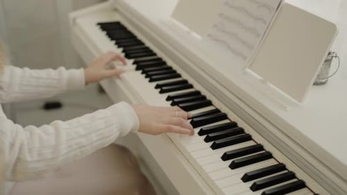 Woman Plays Piano Indoors During the Daytime