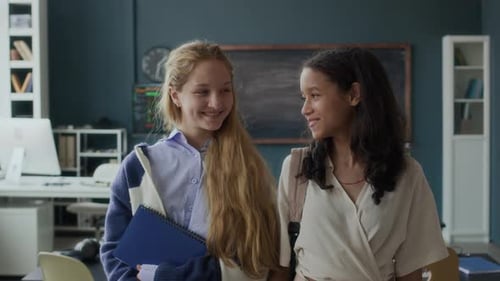 Two Smiling Students Posing Together in Classroom