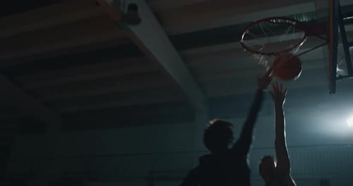 Cinematic slow motion close up shot of young professional male players are practicing a basketball