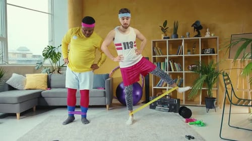Two Young Adults Exercising with Resistance Bands at Home