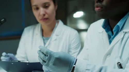 Lab Technicians Reviewing Evidence in Laboratory