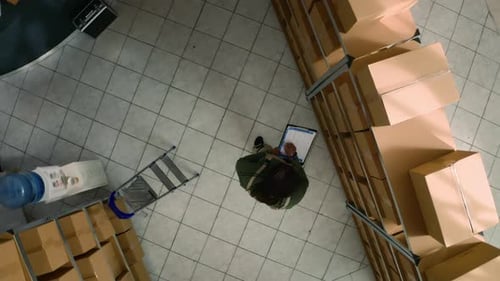 Warehouse Supervisor Examines Parcels