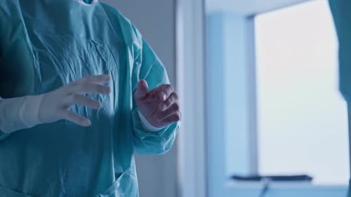 Medical Staff Preparing Putting on Surgical Gloves