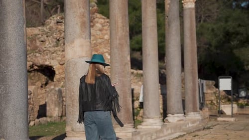 Aerial Video of Woman in Hat Touring Old Ruins