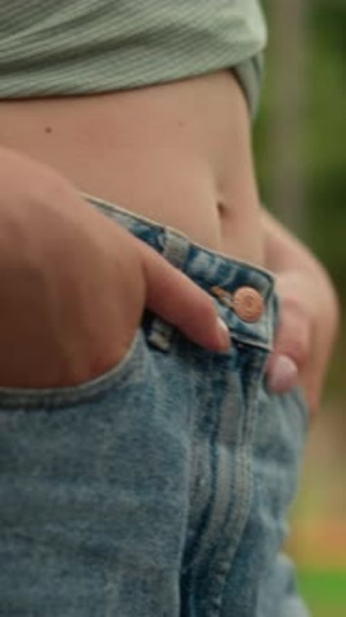 Woman with Hands in Jean Pockets Close Up