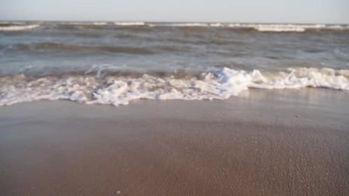 Waves Washing onto Brown Sand Beach in Daytime