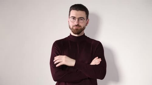 Handsome man with glasses posing on white background