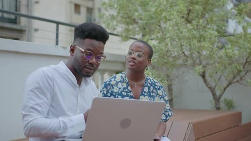 Young Adults Working on Laptop in City