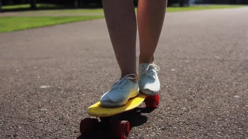 Skateboarding, Leisure, Extreme Sport and People Concept - Teenage Girl Legs Riding