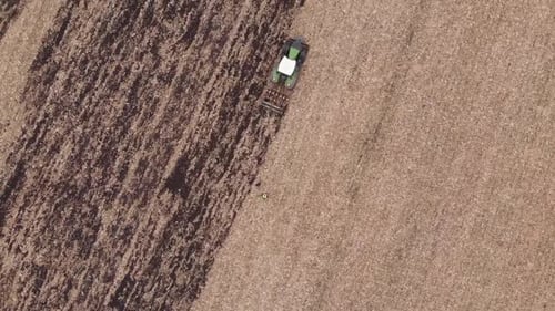 Tractor works in the field doing tillage in Ukraine