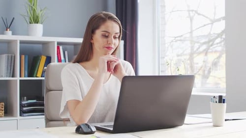 Young Woman Works at Home Office Using Computer Workplace of Female Entrepreneur Freelancer or