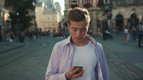 Face Young Happy Man Walk on Street Use Phone Look Around Smile Sunlight Cute Work Mobile Gadget