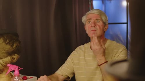 Adult Sits and Ponders in Front of Mirror