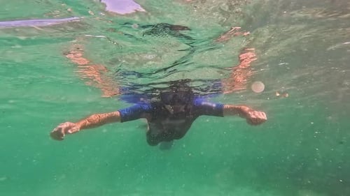 Man Underwater Snorkeling in the Summer