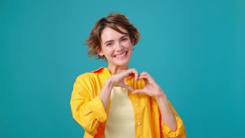 Young Woman Posing and Smiling on Cyan Background
