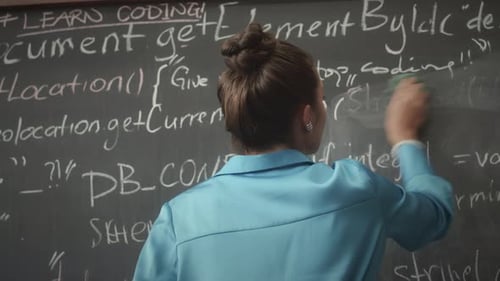 Female Programmer Writing Code on Blackboard