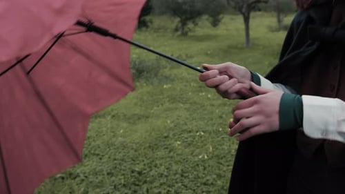 Caucasian Woman Opens Red Umbrella For Rain On A Meadow In Forest