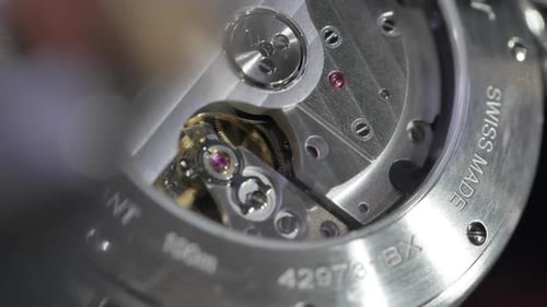 Moving mechanical parts on back of Cartier luxury wristwatch clockwork mechanism, Slow motion