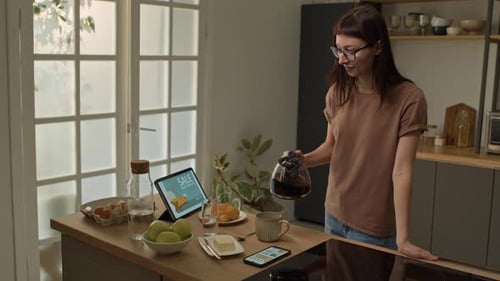 Young Girl Browsing Online Store Offers while Having Morning Breakfast