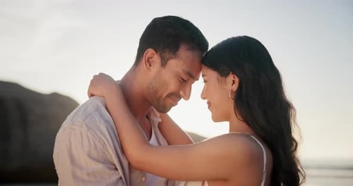 Happy couple, beach and romantic care with hug on holiday, sunset and together for bonding