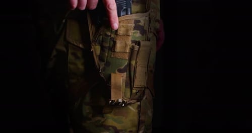 Hand Draws Black Gun from Holster, Close Up