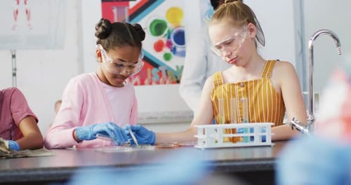 Diverse happy schoolchildren having science class in school lab
