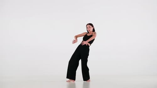 Woman Dancing Barefoot in a White Studio
