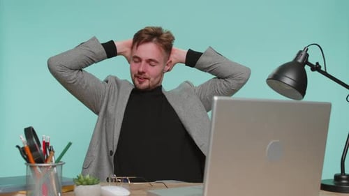 Tired Young Man Working at Office Desk