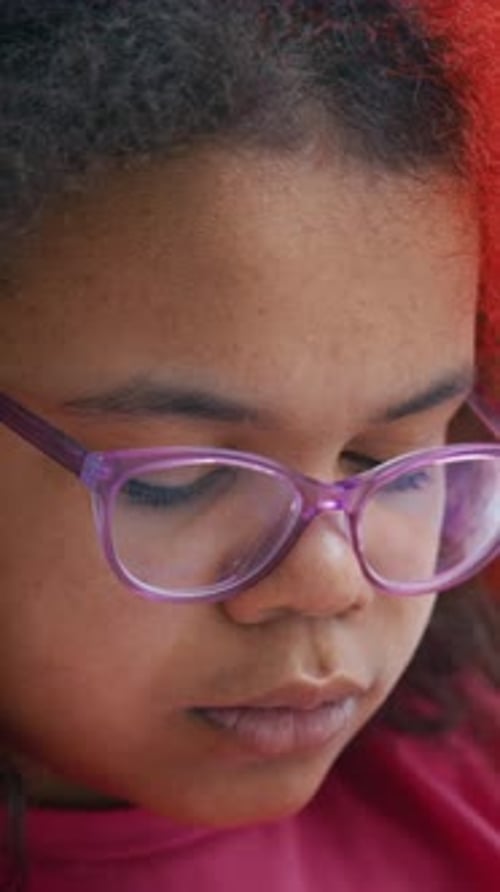 Child Focused on Reading Quietly Indoors During a Cozy Afternoon