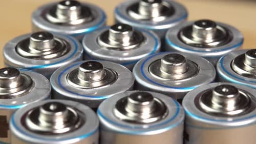 Rows of used alkaline AA batteries. Lithium ion battery pack close up. Electric power supply